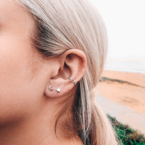 Model photo wearing sterling silver moon and star stud earrings