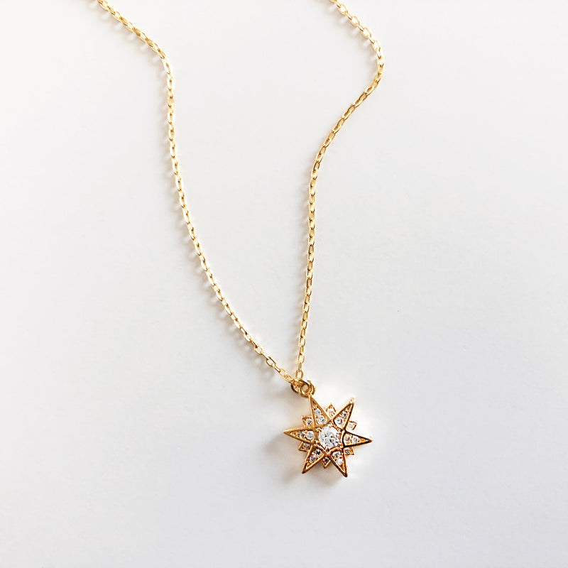 Gold multi-point star charm necklace 