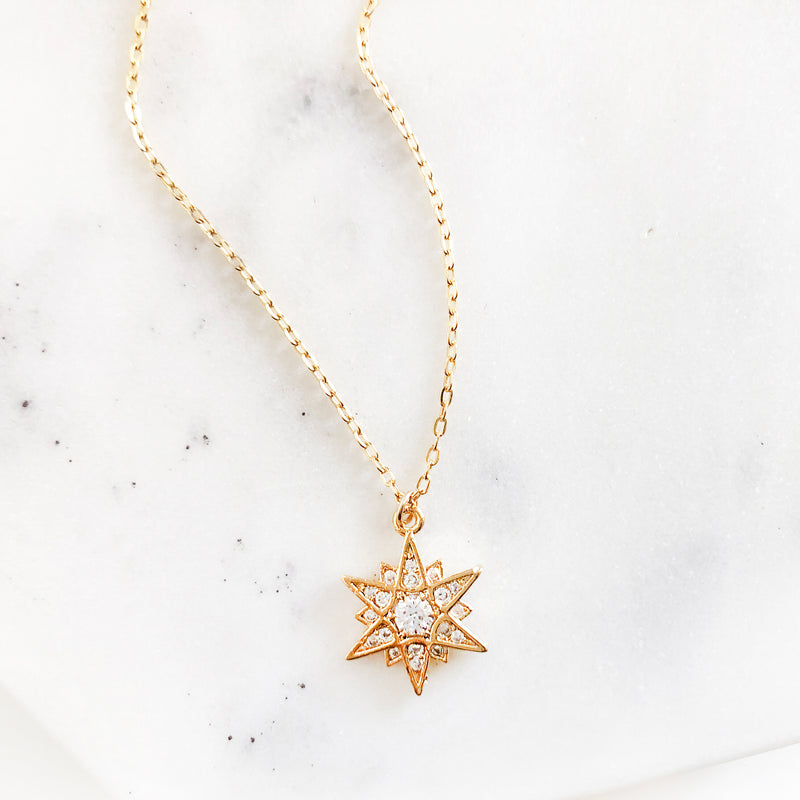 Gold multi-point star charm necklace 