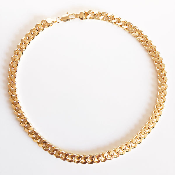 Chunky gold cuban link Anubis chain flat lay display