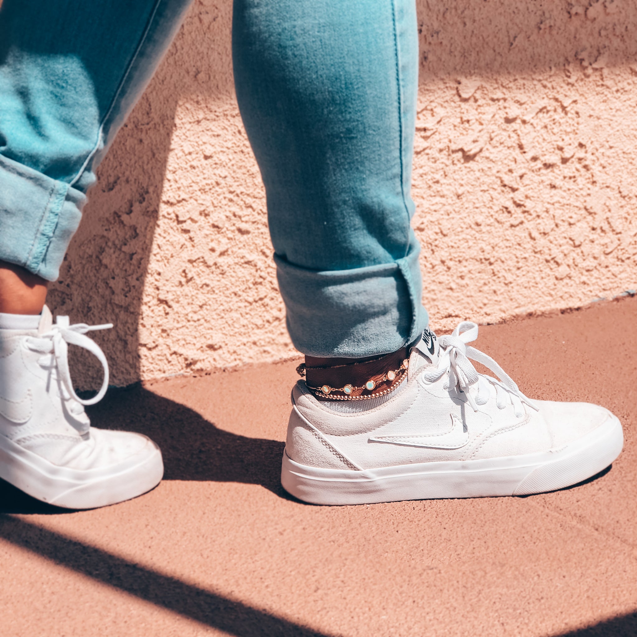 Model wearing gold and opalite anklet layered with a 3mm anklet