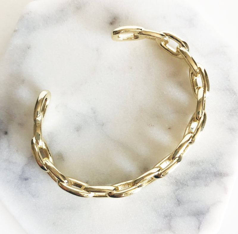 Chunky gold link chain cuff bracelet flat lay display