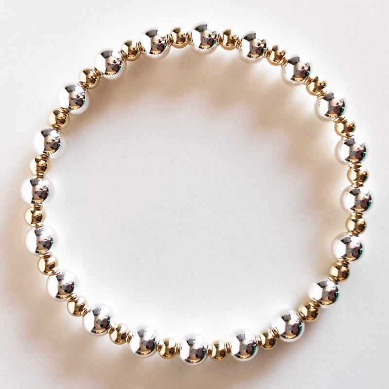 6mm silver and 4mm gold alternating beaded bracelet flat lay display