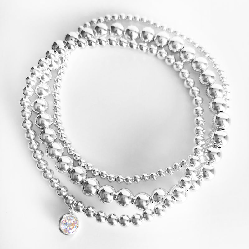 Sterling Silver beaded stack of bracelets with a round Swarovski crystal charm