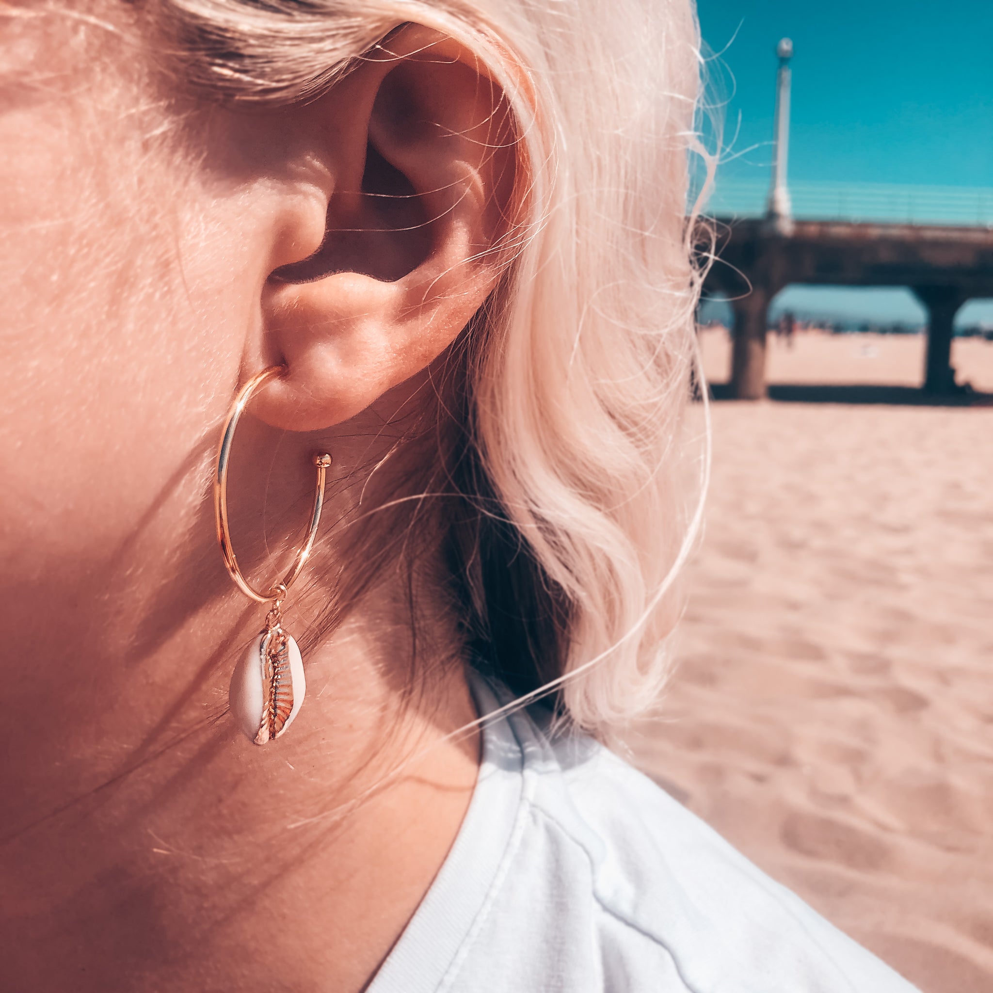 Model photo wearing 14K Gold-Filled hoop with seashell dangle