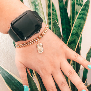 Model photo wearing 14k Gold-Filled cuban link chain bracelet with cool abstract shape charm with extender with Apple Watch 