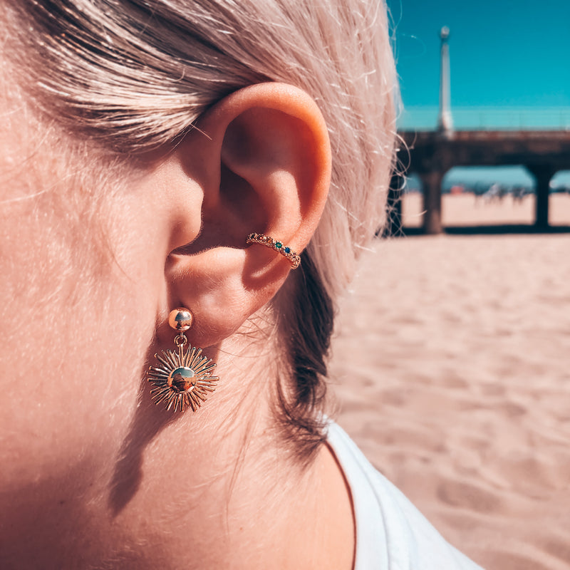 Model photo wearing Dangling sunburst on 6mm ball post 14k gold-filled earrings and rainbow ear cuff