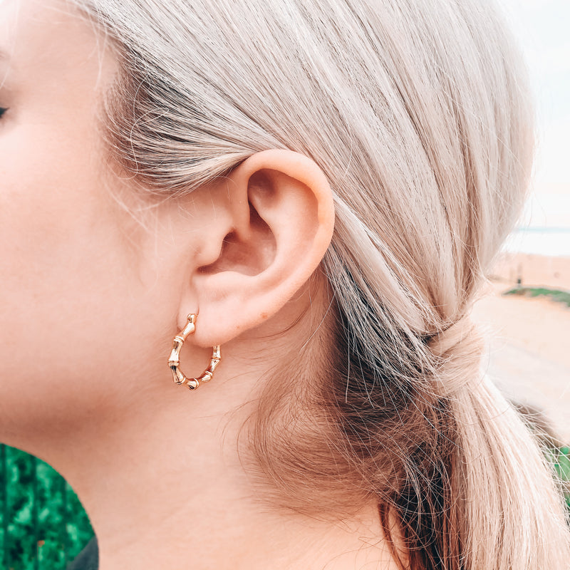 Model photo wearing 14k gold-filled small chunky bamboo hoops