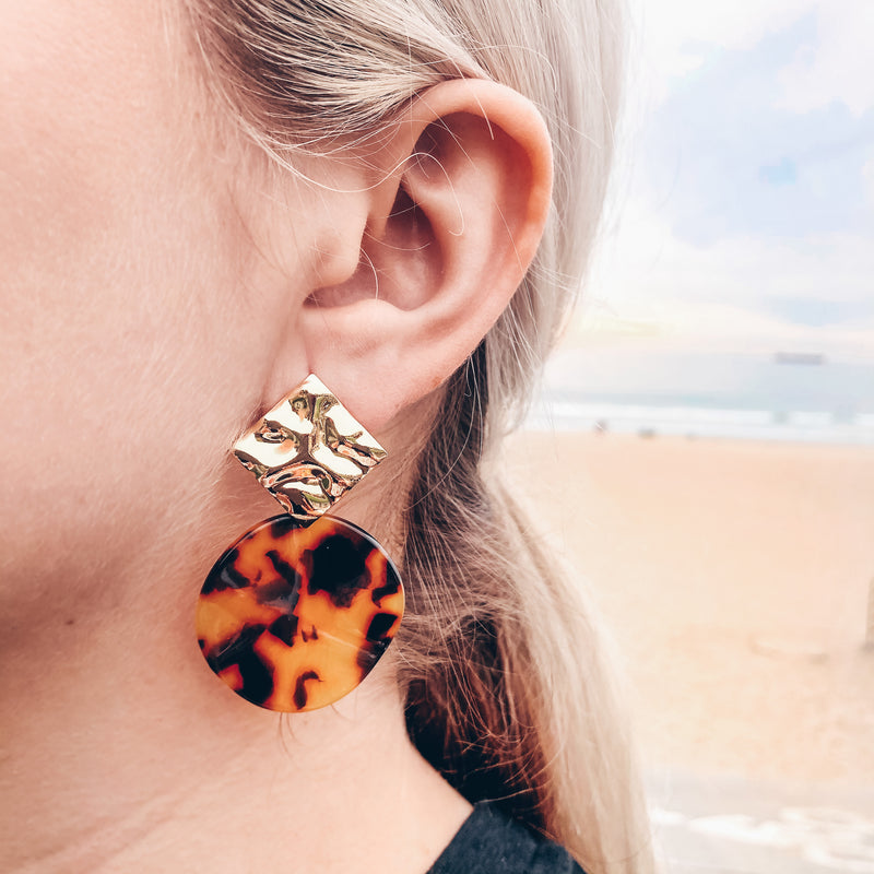 Model photo wearing 14k gold-filled and classic tortoiseshell acetate chunky earrings