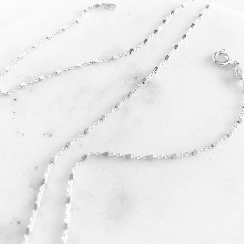 Up close detail of Dainty sterling silver chain necklace sparkling