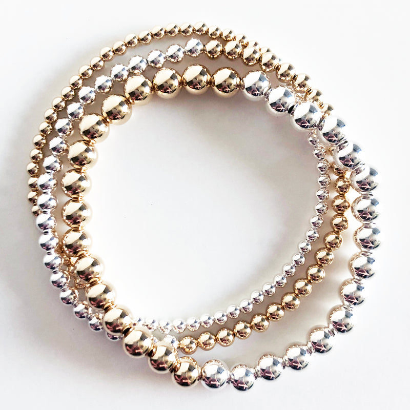triple stack of half 14k gold-filled and half sterling silver beaded bracelets in 3mm, 4mm, and 6mm bead sizes