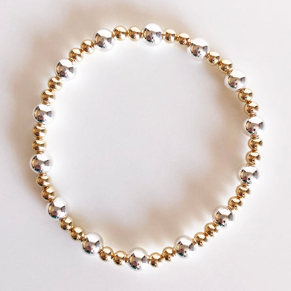 6mm silver and 4mm gold alternating beaded bracelet flat lay display