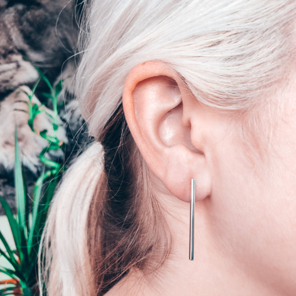 Model photo wearing Sterling Silver minimal stick post drop earrings