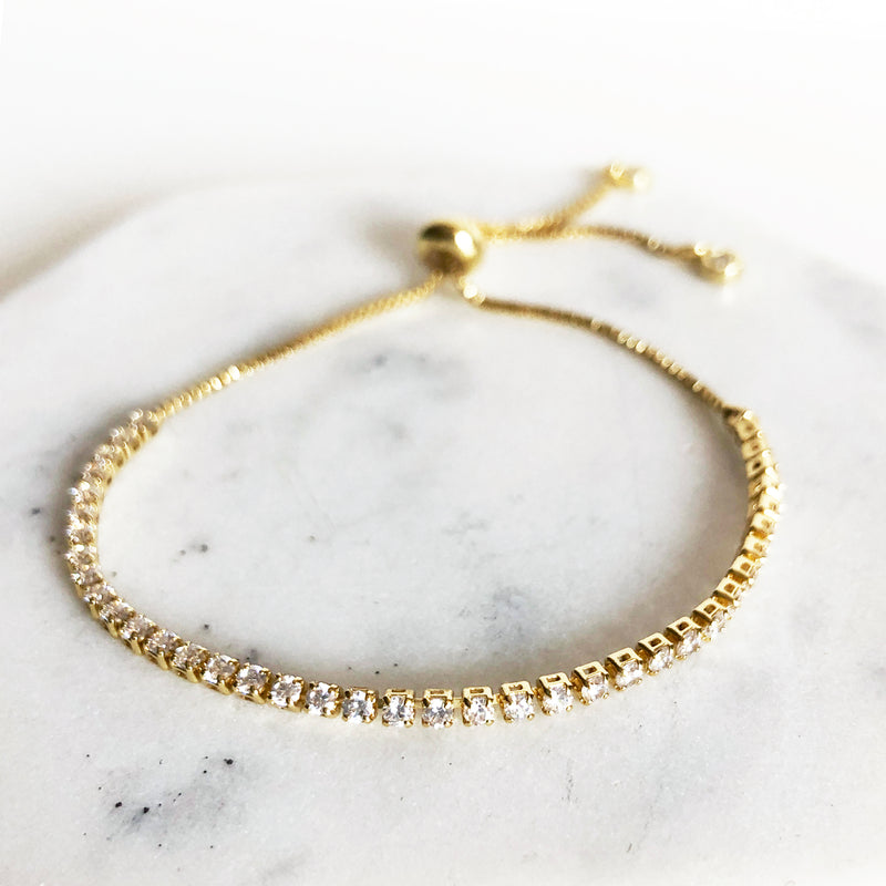14k gold-filled CZ tennis bracelet with box chain and bolo slider closure up close detail view