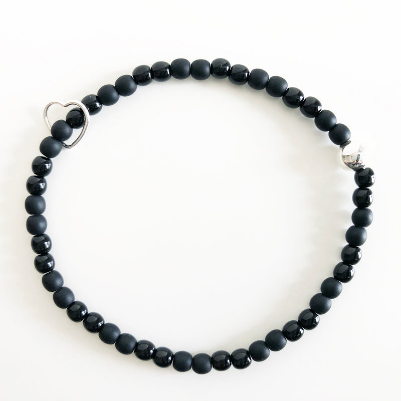 Czech glass beaded bracelet in black with alternating gloss and matte beads with silver accent beads and heart charm